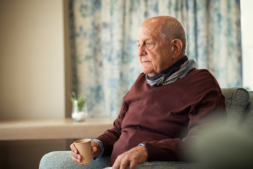 Elderly man recovering at home during cancer treatment